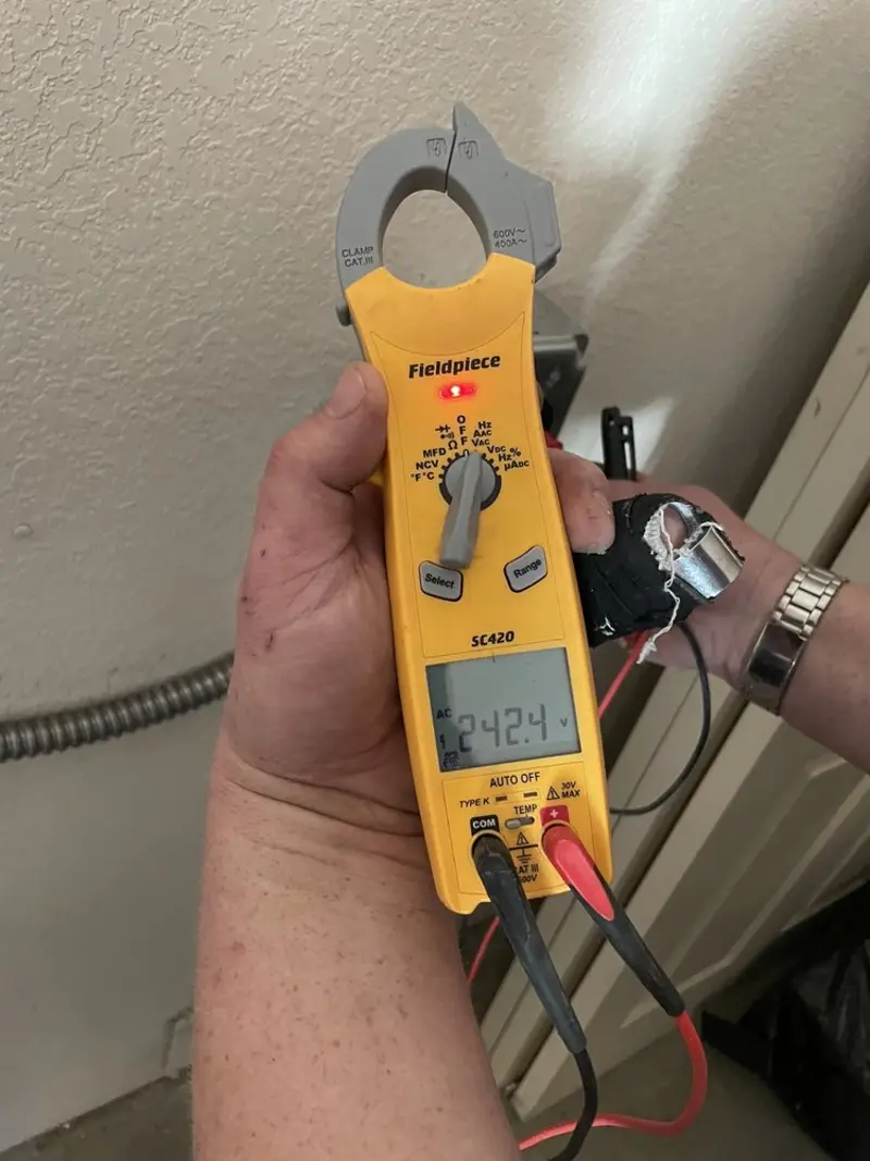 Voltage testing with clamp meter during Ceiling Fan Installation in Clearfield